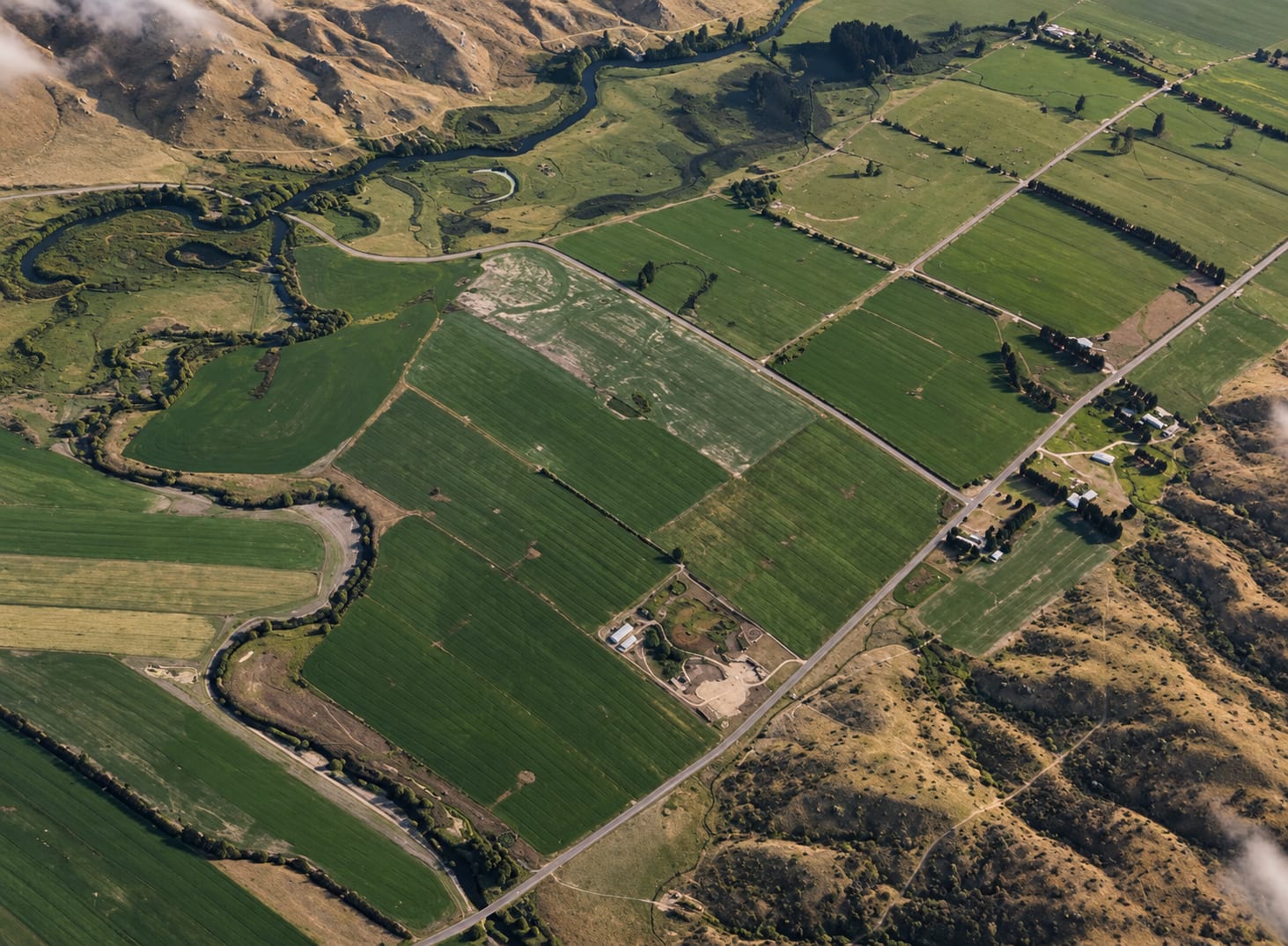 Farmland from the air, its boundary traced in orange
